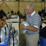 Daryl Lamonica autographing helmets for National Sports Distributors