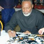 LC Greenwood autographing Steel Curtain 16x20 photos for National Sports Distributors