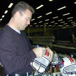 Howie Long autographing helmets for National Sports Distributors