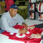 Ronnie Lott autographing jerseys for National Sports Distributors
