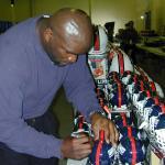 Lawrence Taylor autographing helmets for National Sports Distributors