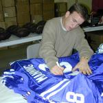 Peyton Manning autographing jerseys for National Sports Distributors