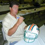 Dan Marino autographing helmets for National Sports Distributors