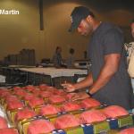 Curtis Martin autographing footballs for National Sports Distributors