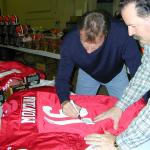 Joe Montana autographing jerseys for National Sports Distributors