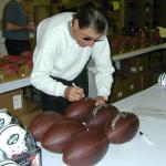 Joe Namath signing footballs for National Sports Distributors