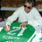 Joe Namath autographing jerseys for National Sports Distributors