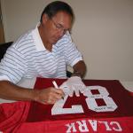 Dwight Clark autographing jerseys for National Sports Distributors
