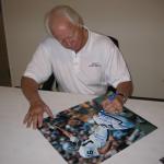 Ken Stabler autographing 16 x20 photos for National Sports Distributors
