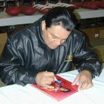 Roberto Duran autographing 8x10 photos for NSD