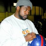 Ron Dayne autographing helmets for National Sports Distributors