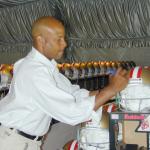 Ronnie Lott autographing helmets for National Sports Distributors