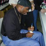 Deion Sanders autographing baseballs for National Sports Distributors