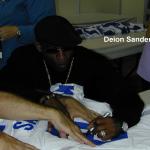 Deion Sanders working with Rob Hemphill of NSD while autographing authentic jerseys for National Sports Distributors