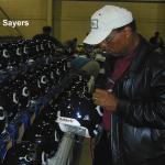 Gale Sayers autographing helmets for National Sports Distributors