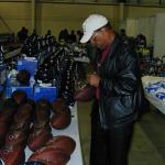 Gale Sayers autographing throwback Duke footballs for National Sports Distributors
