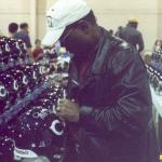 Gale Sayers signing helmets for National Sports Distributors