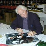 Ken Stabler autographing 16x20 photos for National Sports Distributors