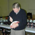 Johnny Unitas autographing footballs for National Sports Distributors