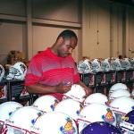 Warren Moon autograping helmets for National Sports Distributors