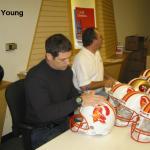 Steve Young autographing helmets for National Sports Distributors