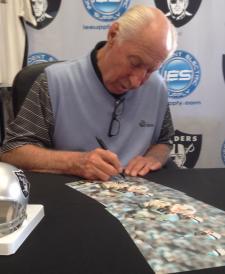 Fred Biletnikoff signing 8x10 photos for NSD